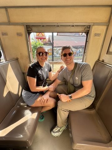 Couple at Thai restaurant with food spread
