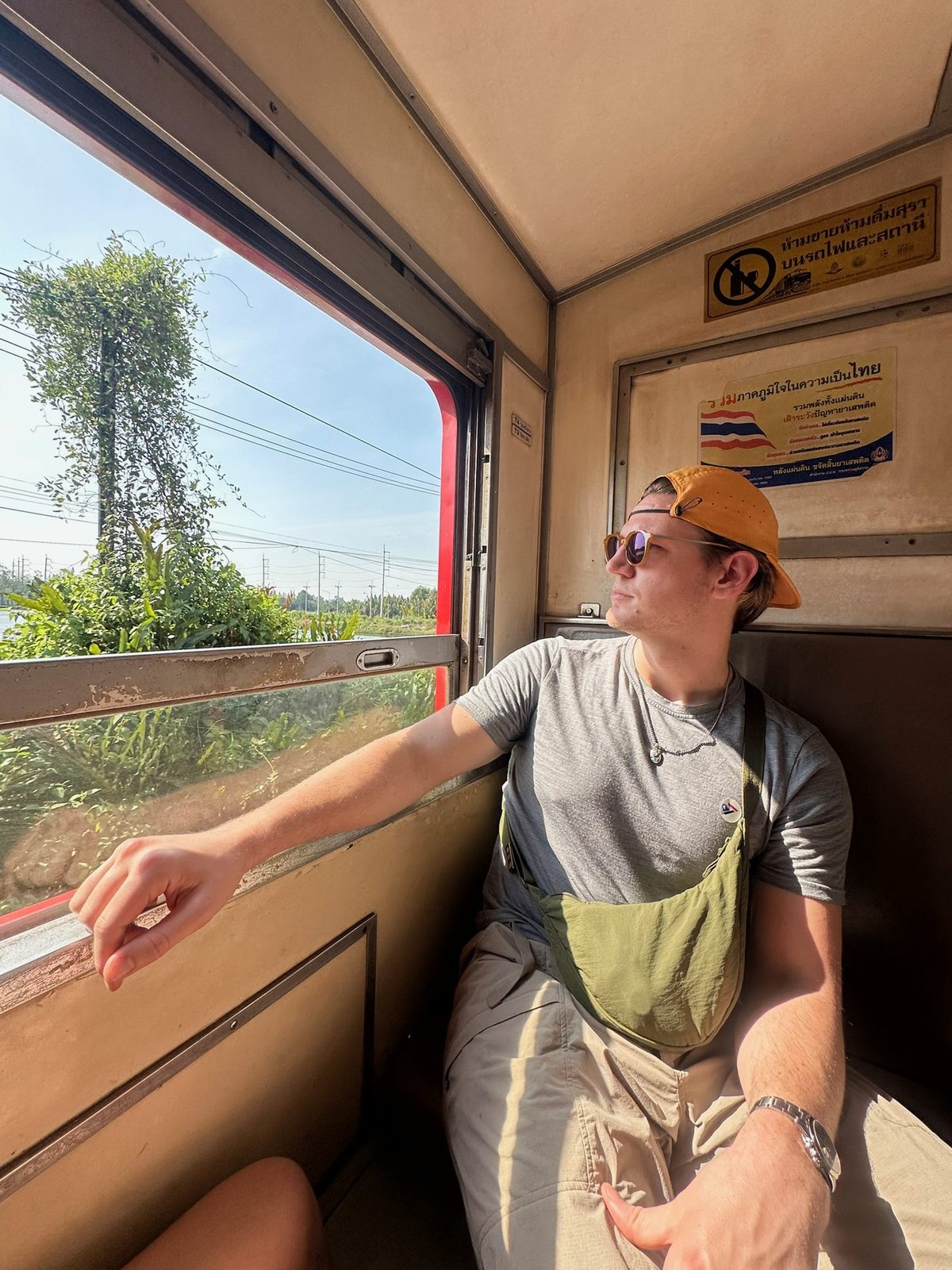Ryker looking out Maeklong train window