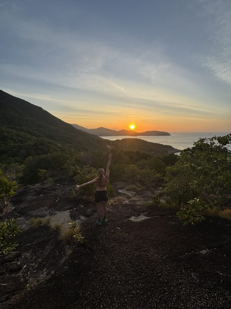 Meg arms up at sunset hike