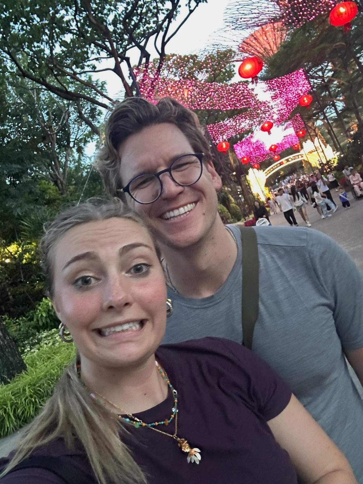 Meg and Ryker selfie with red CNY lanterns and Supertrees behind