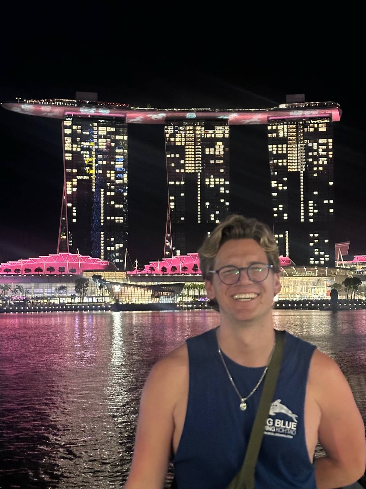 Ryker in front of Marina Bay Sands lit up at night