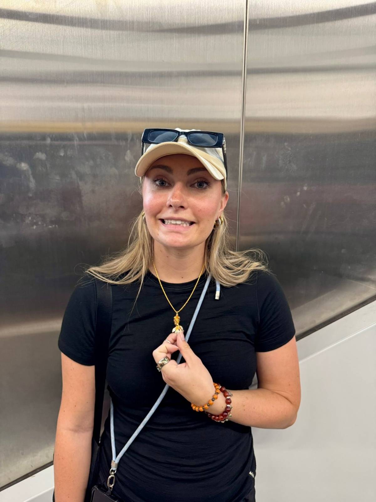 Meg in the elevator after the Seiko store disappointment