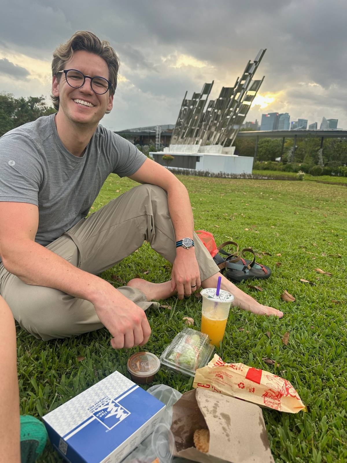 Ryker at the picnic on the grass with Singapore skyline behind