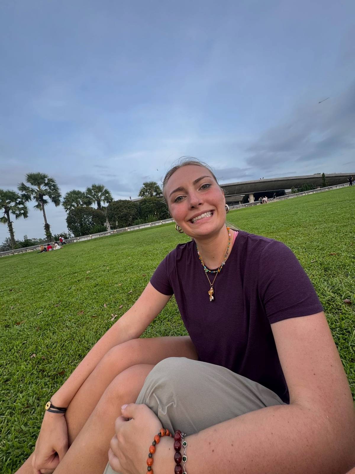 Meg sitting on the grass at the waterfront picnic