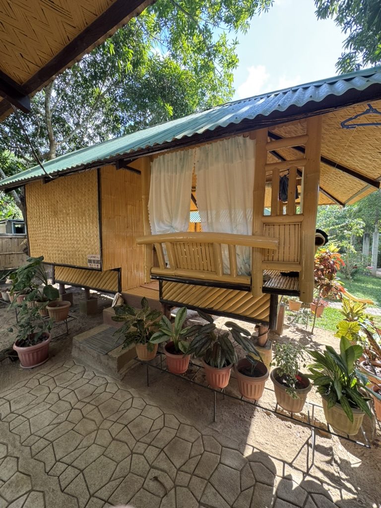 Bamboo hut with porch and potted plants at the Coron Airbnb