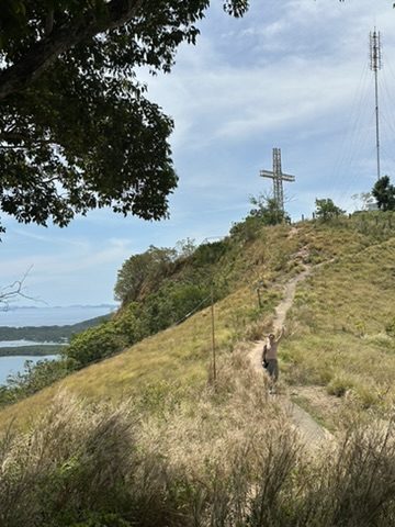 Trail leading up to the hilltop cross above Coron town, ocean visible below