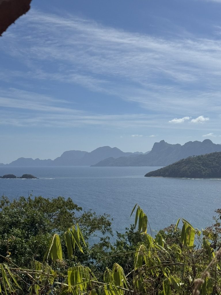 Panoramic view of Palawan islands and open ocean from a hillside along the scooter route