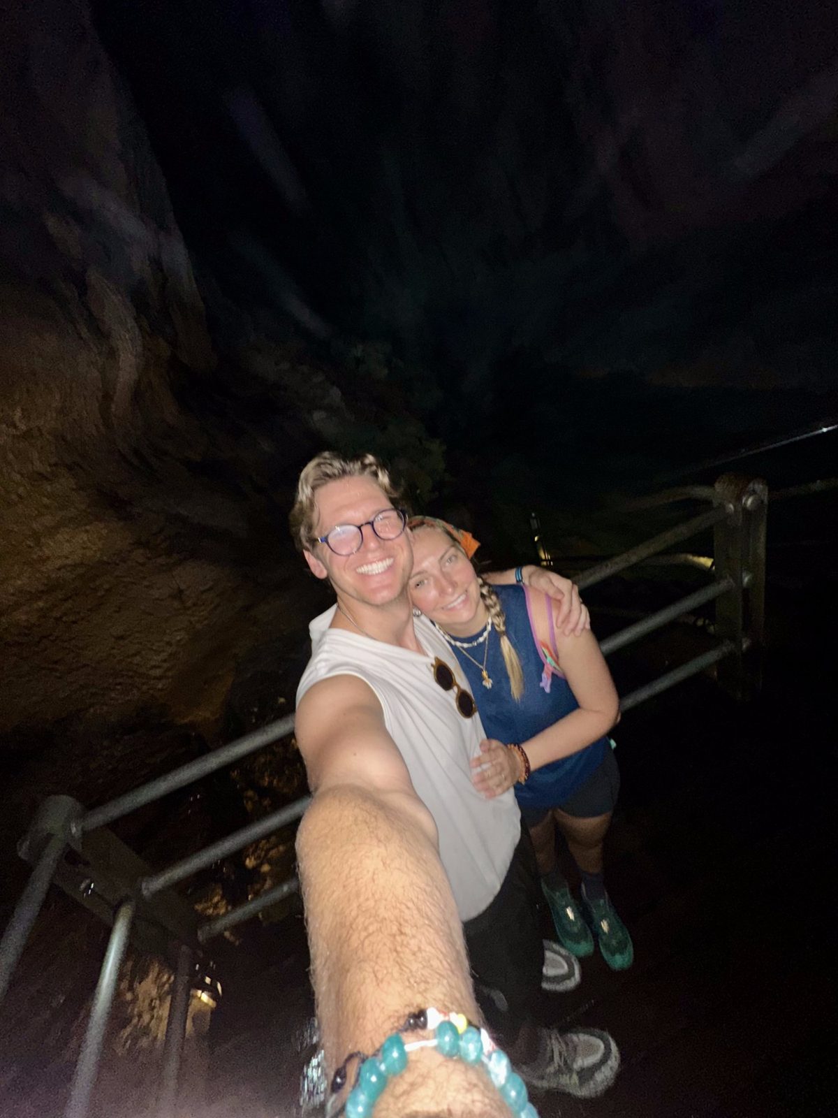 Ryker and Meg smiling selfie deep inside a dark cave on the boardwalk