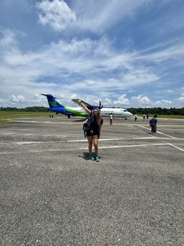 Meg posing triumphantly on the Mulu tarmac in front of the MASWings plane