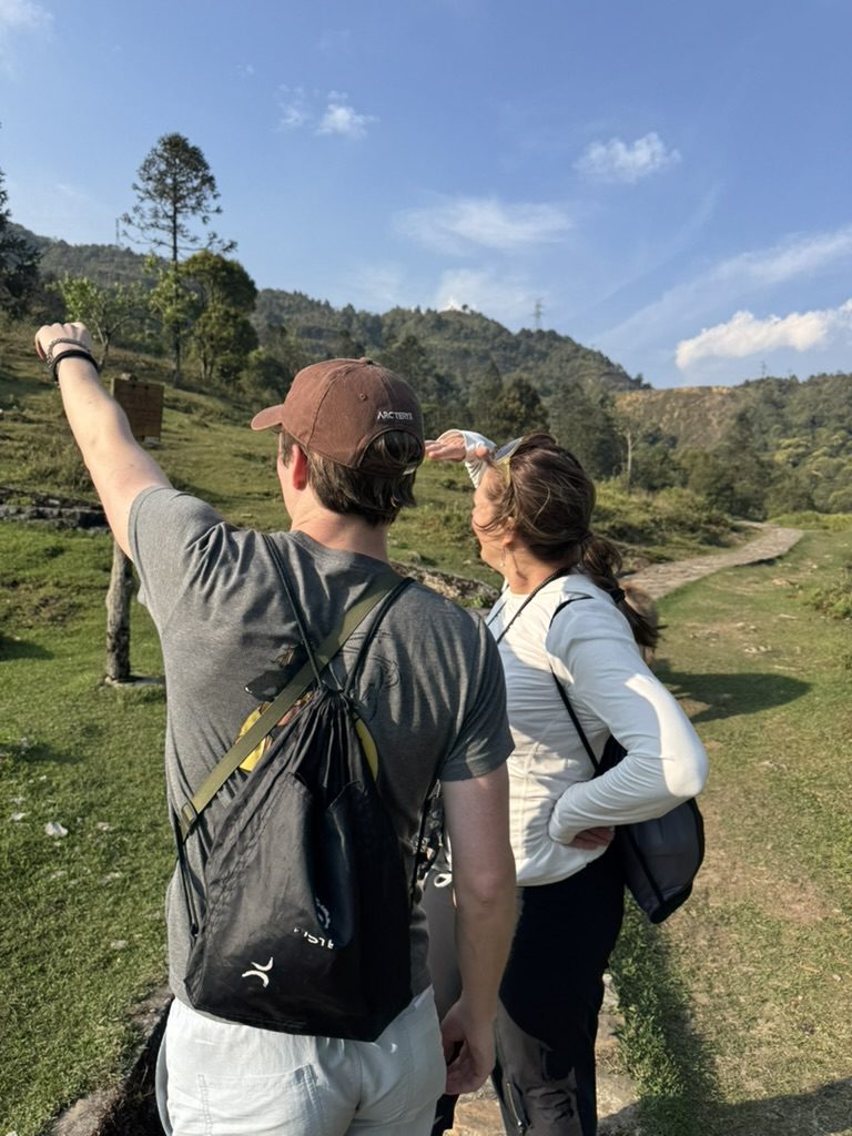 August and Chantel pointing at the mountain views