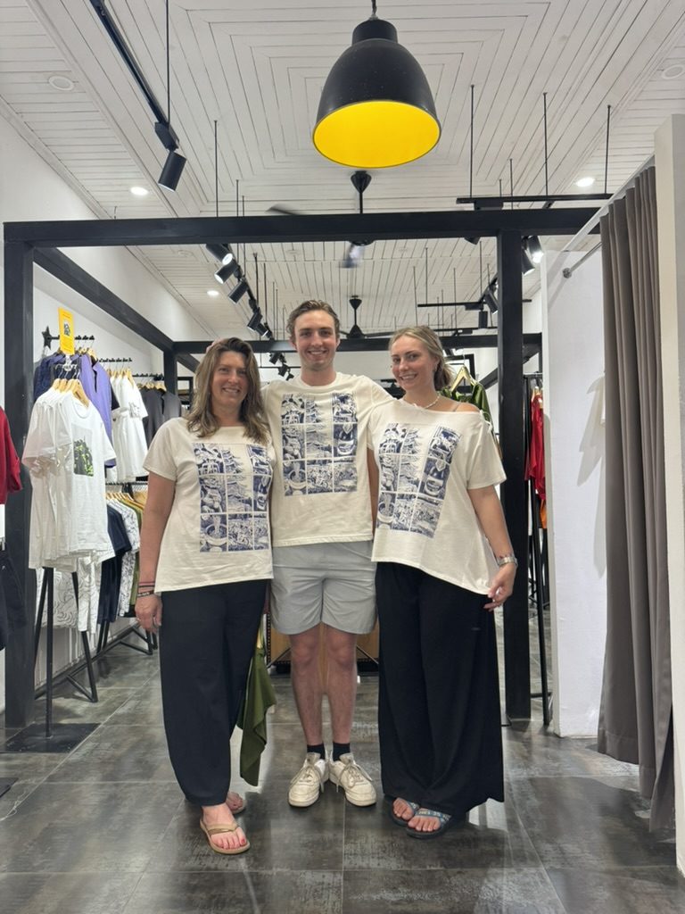 Chantel, August, and Meg in matching graphic tees from Hanoi shopping