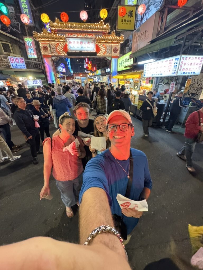 Group at Raohe entrance holding pepper buns