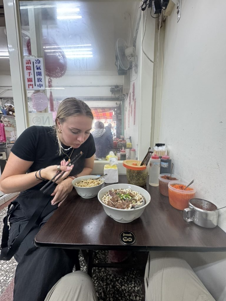 Meg eating beef noodle soup