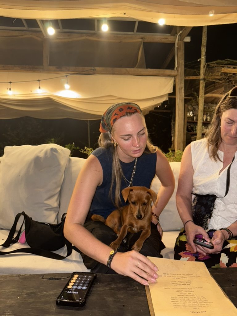 Meg at a Sapa bar cuddling a puppy