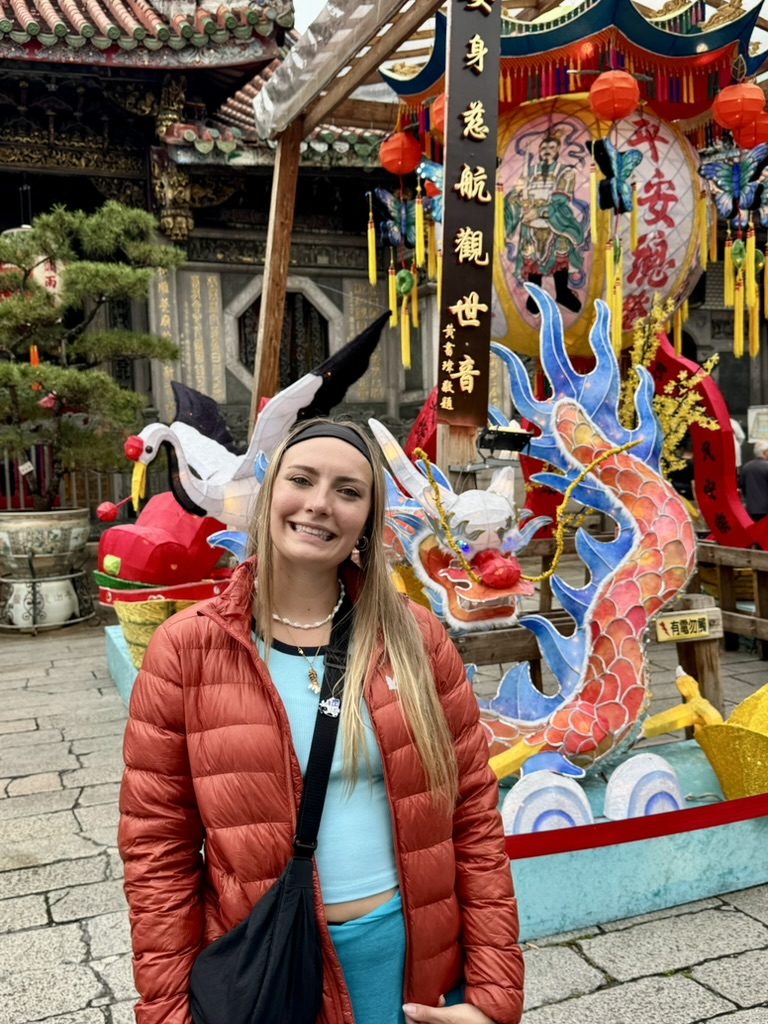 Meg at a temple with dragon lantern decorations