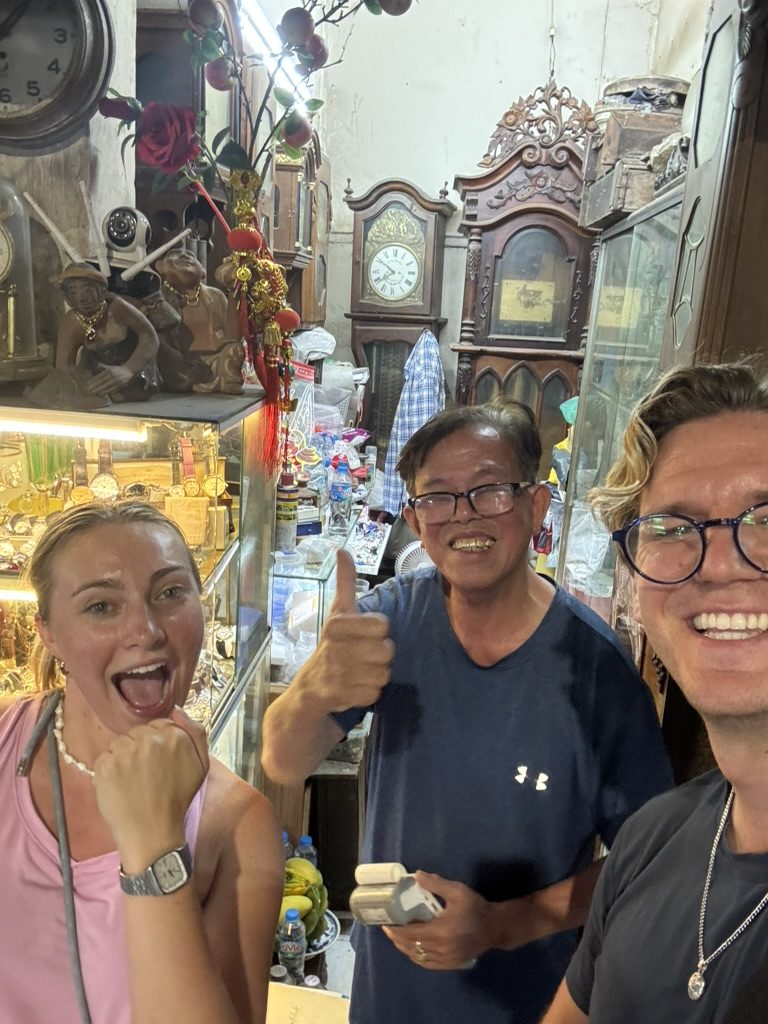 Ryker and Meg with the Hanoi antique watch shop owner