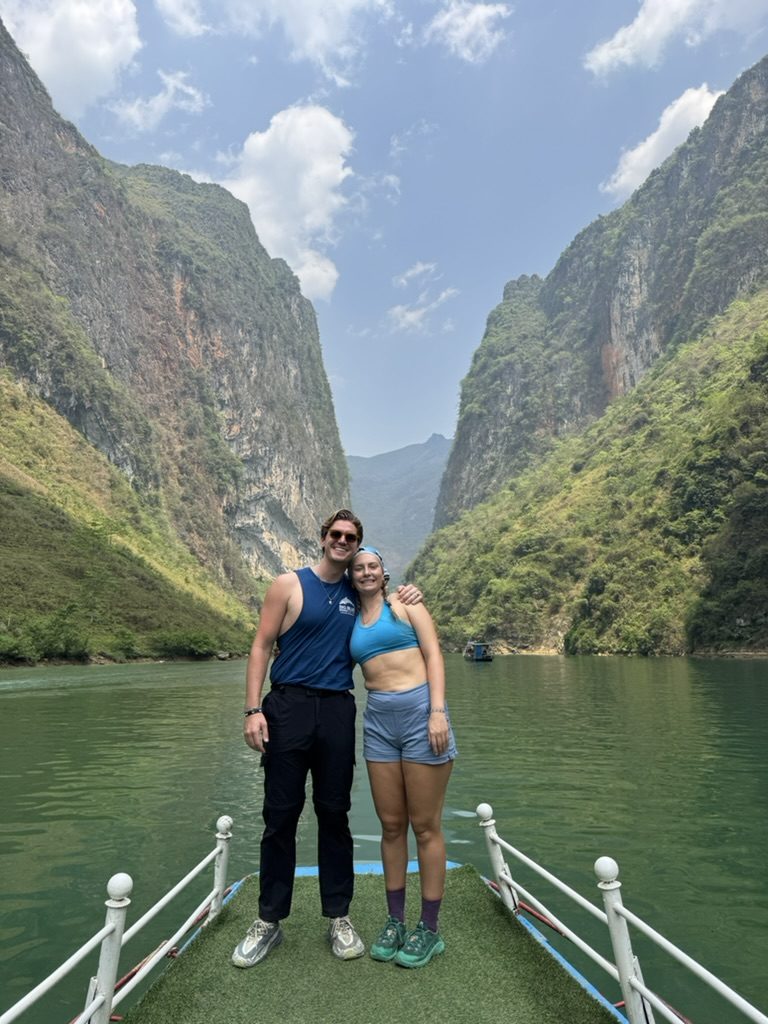 Ryker and Meg on the bow of a boat in the Nho Que River canyon