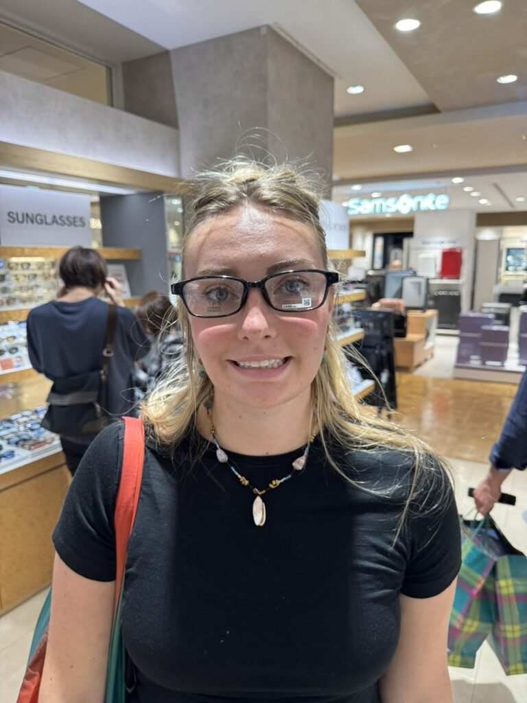Meg trying glasses in Tokyo