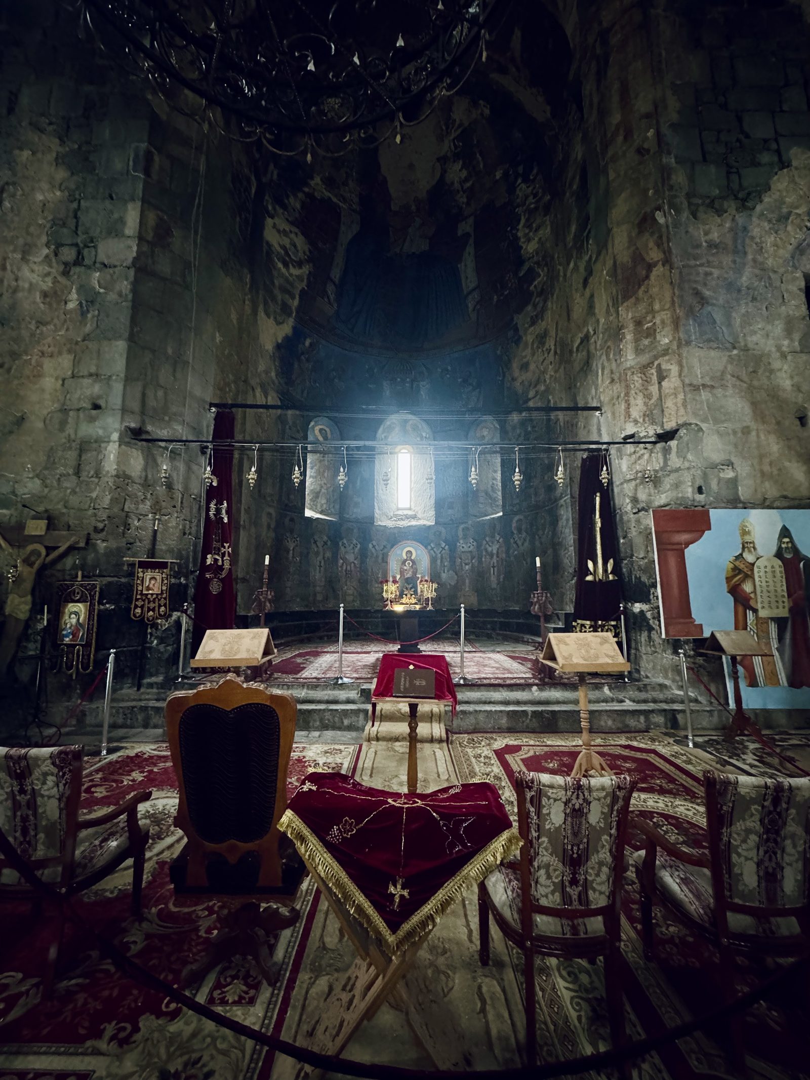 The candlelit interior of an Armenian monastery