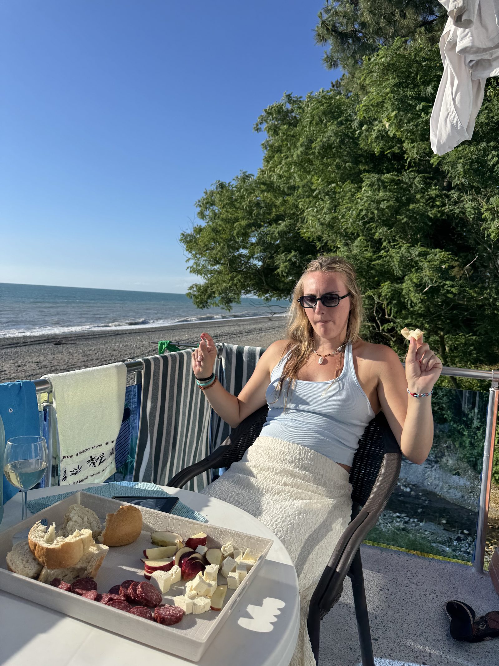 Wine and a snack board on a balcony over the Black Sea