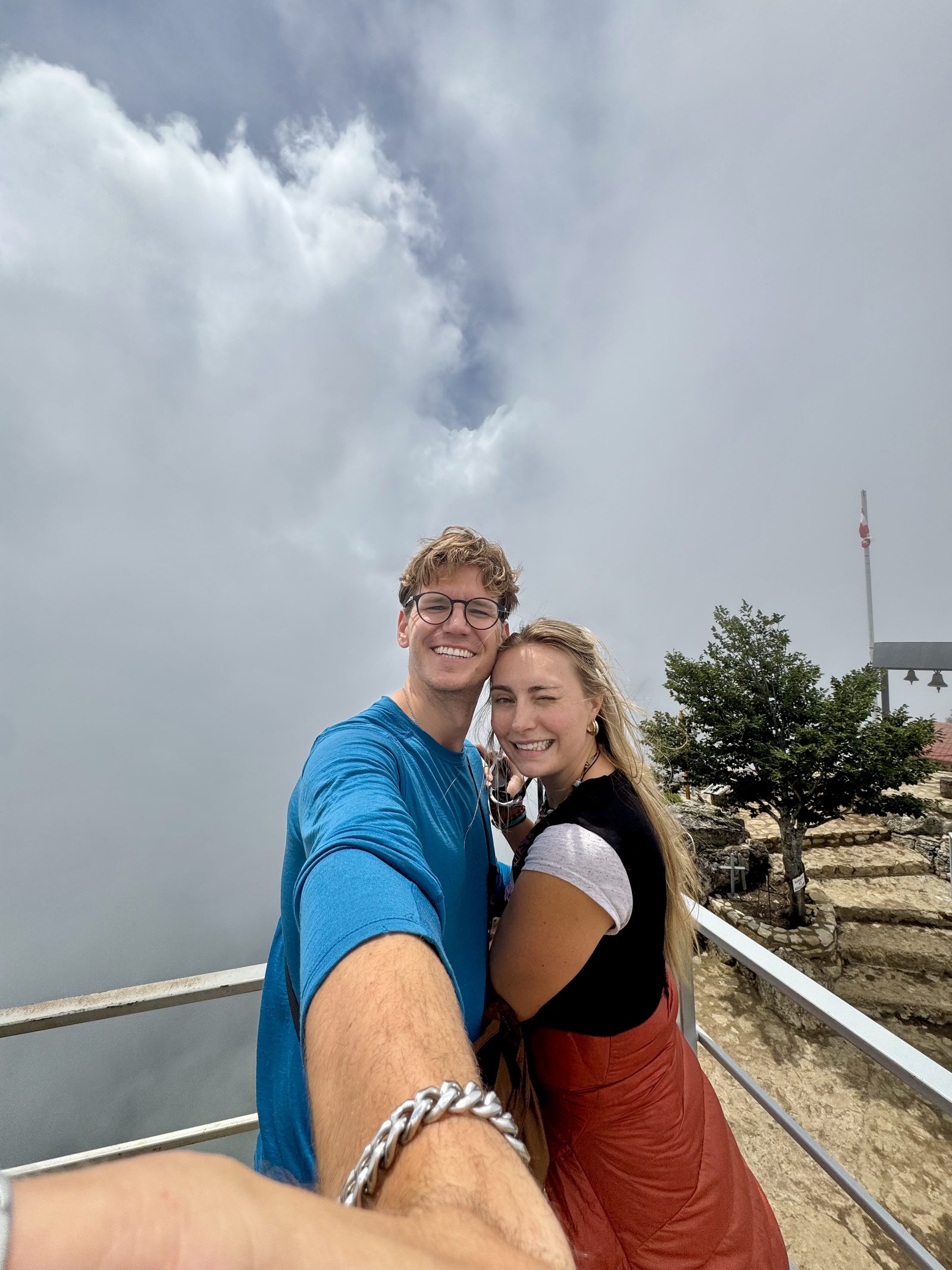 A couple selfie at a windy Georgian summit