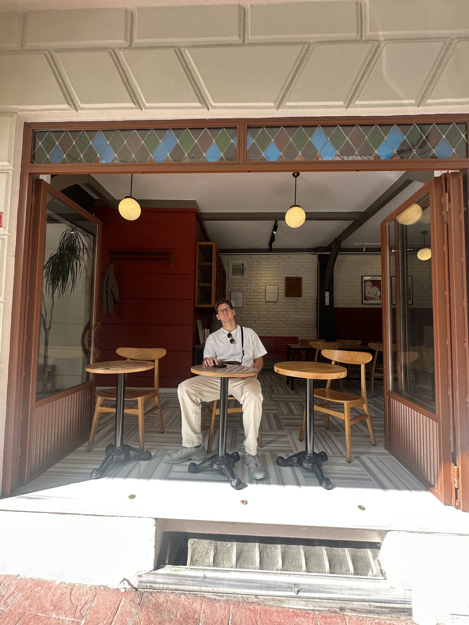 A man sitting inside a cozy Istanbul cafe