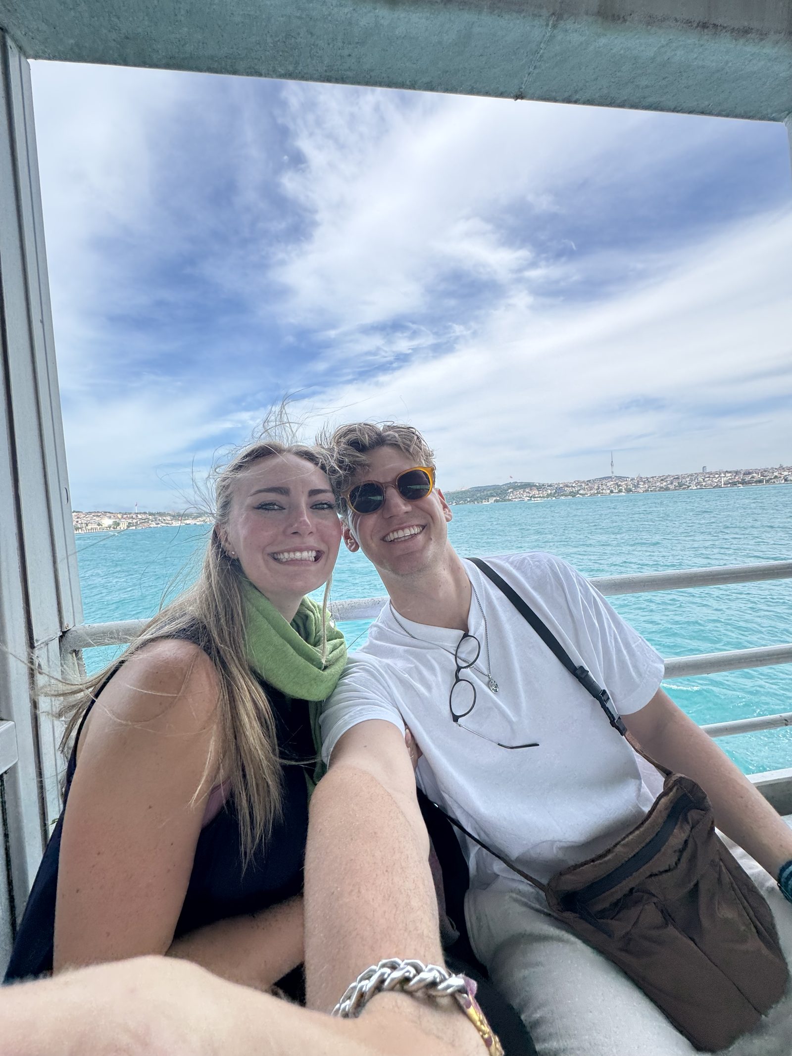 A couple on the ferry with the water behind them