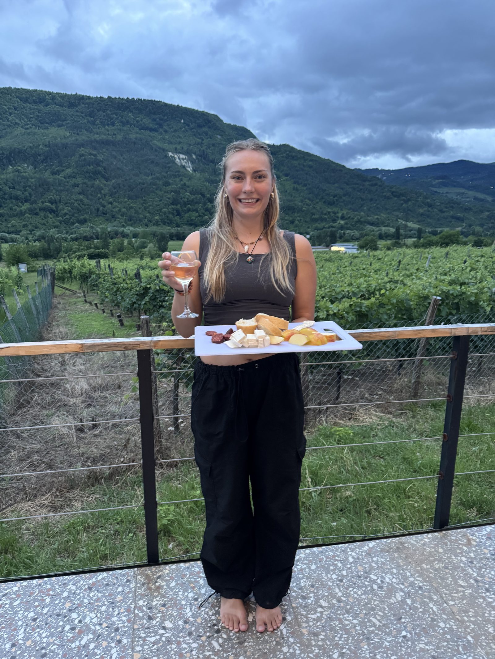 Holding a cheese board on the mountain-facing deck