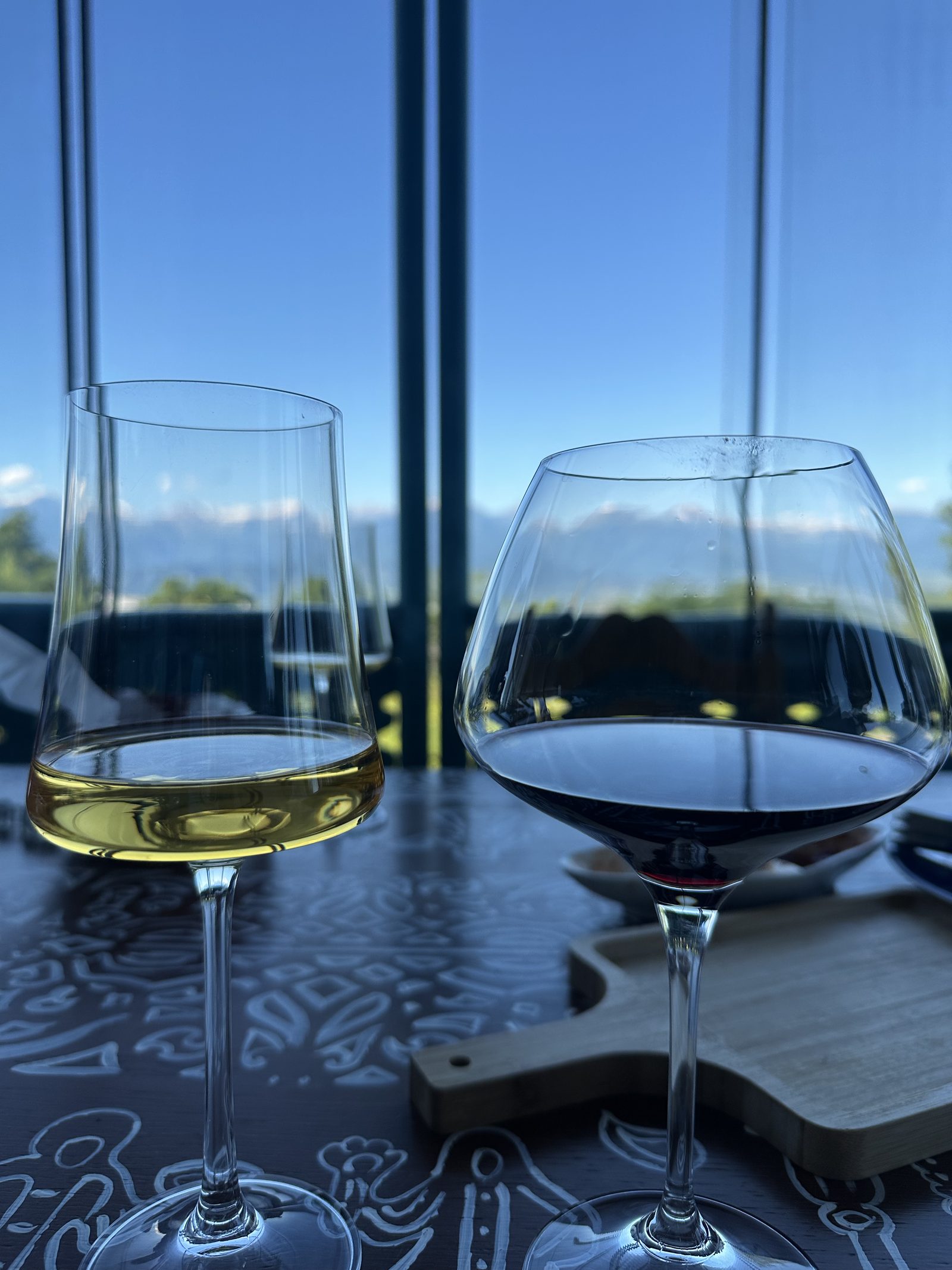 Glasses of white and red Georgian wine at a window