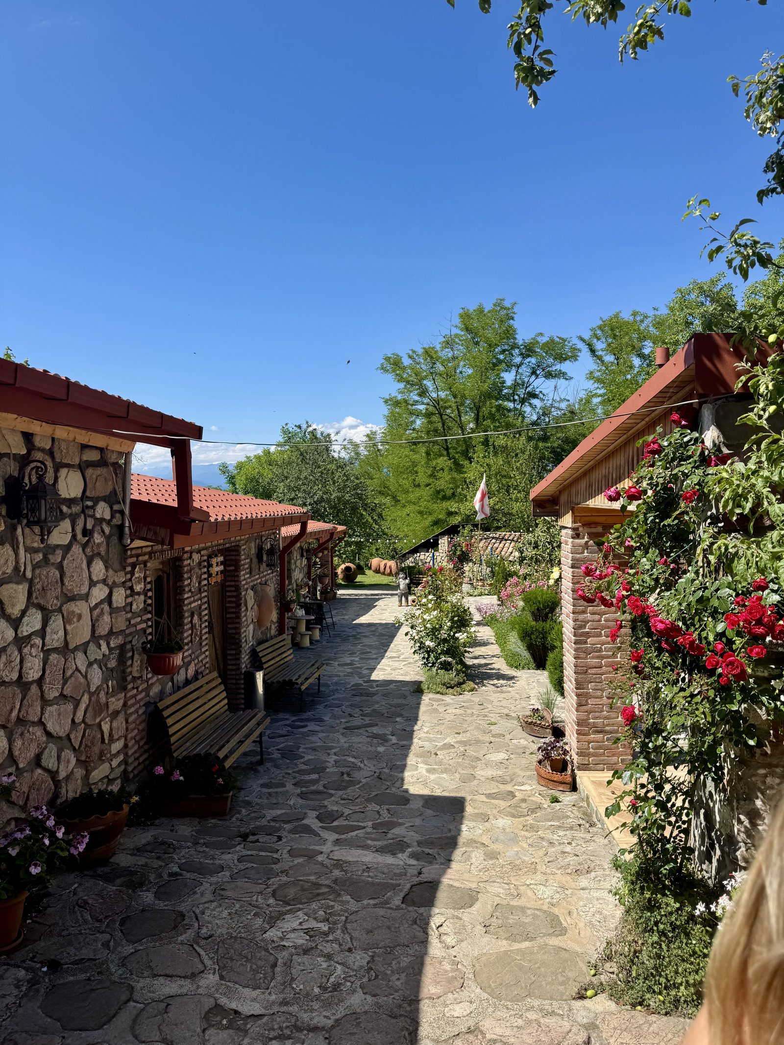 A flower-lined stone winery courtyard