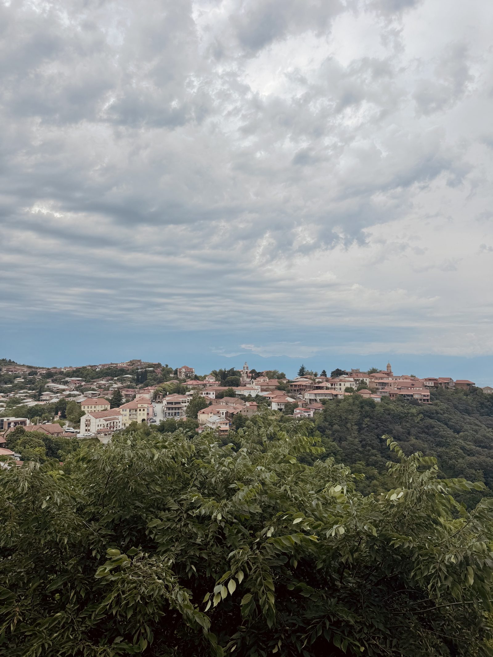 The hilltop town of Sighnaghi under a cloudy sky
