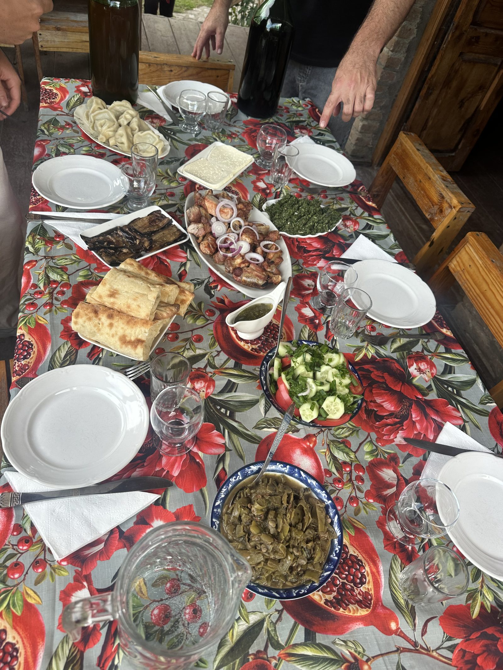 A supra spread of khachapuri, khinkali and salads