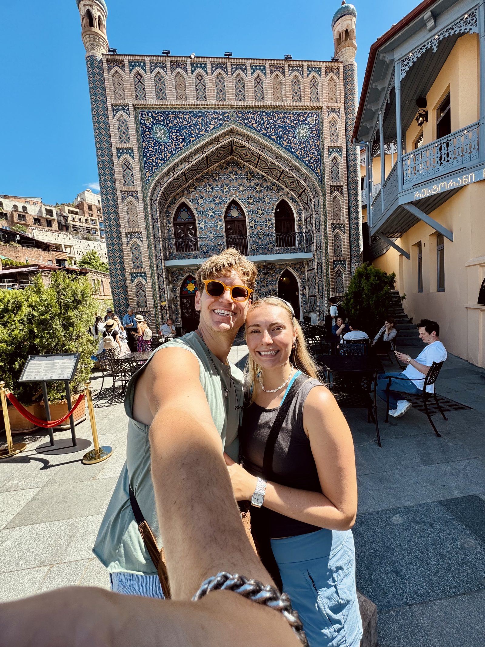 A couple by the tiled facade in the sulfur bath district