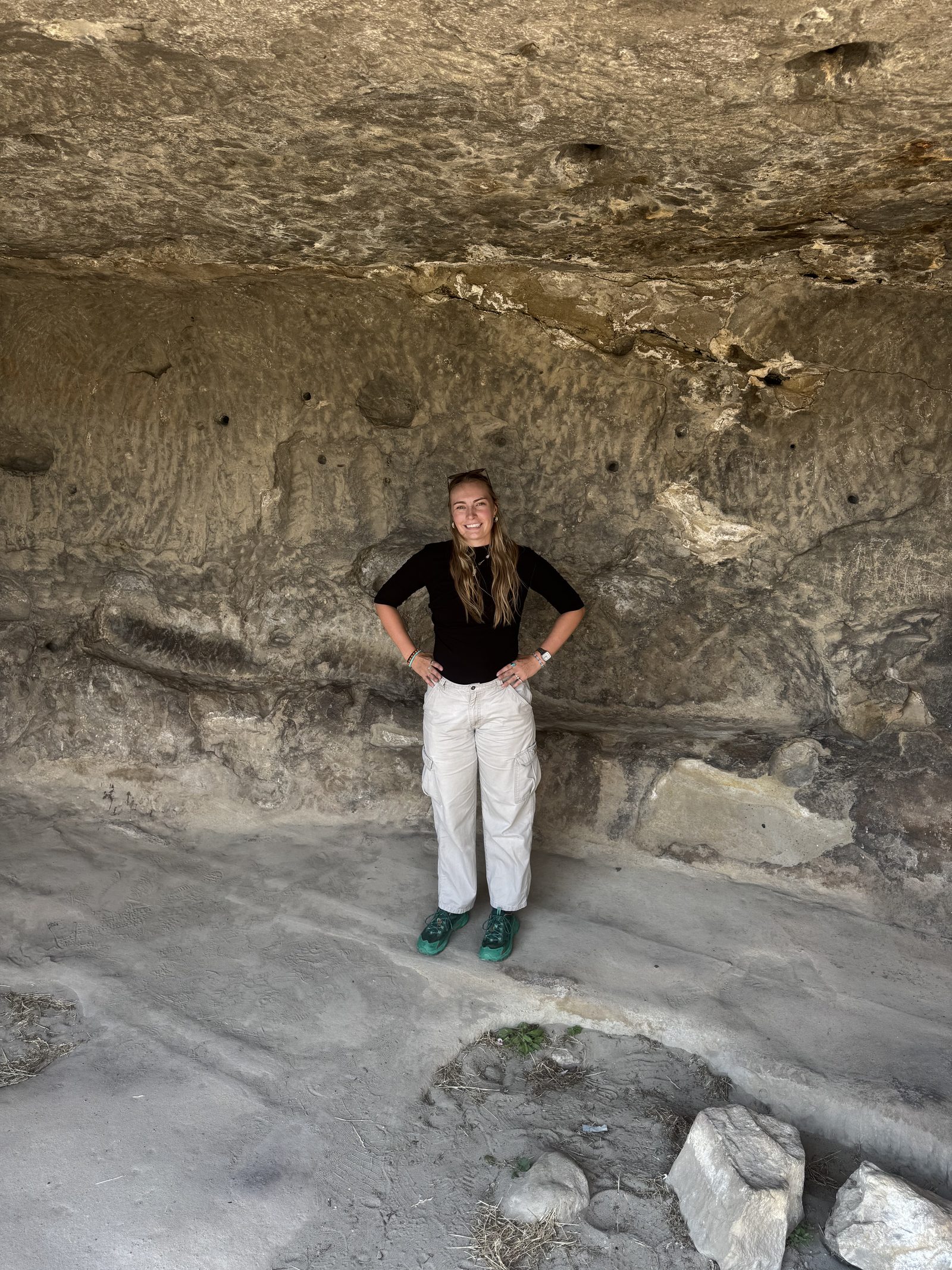 Standing in a carved cave dwelling near Gori