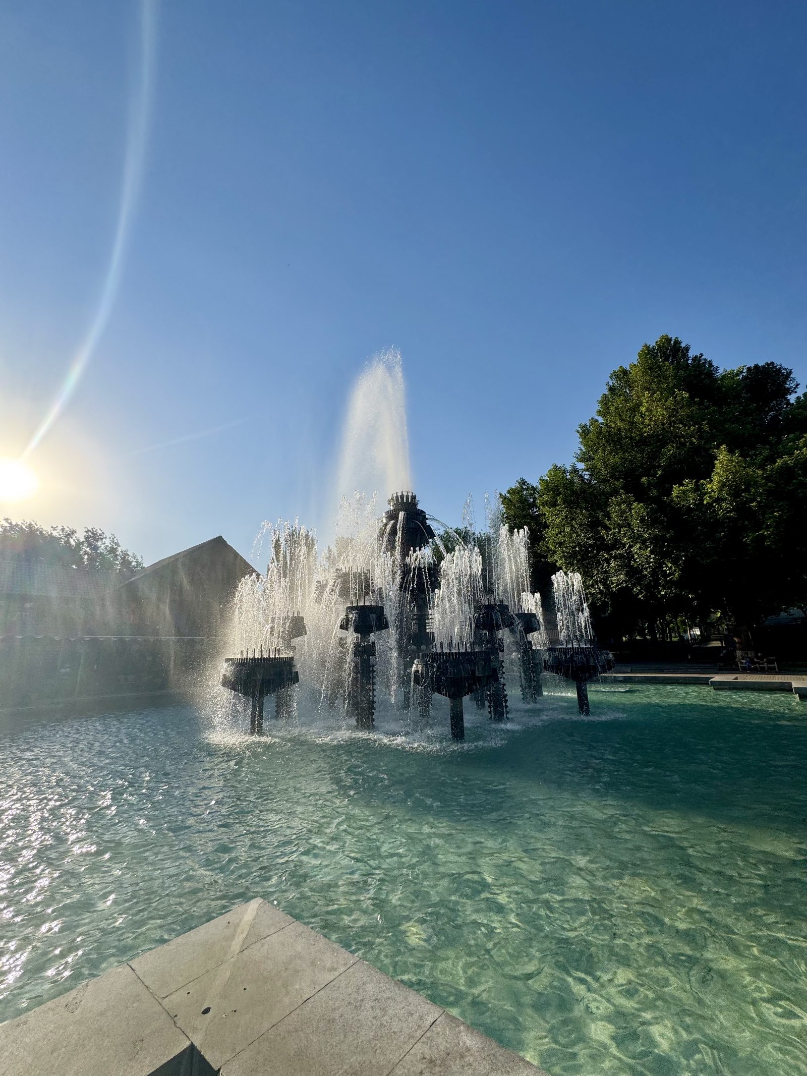 The fountains of Republic Square catching the sun