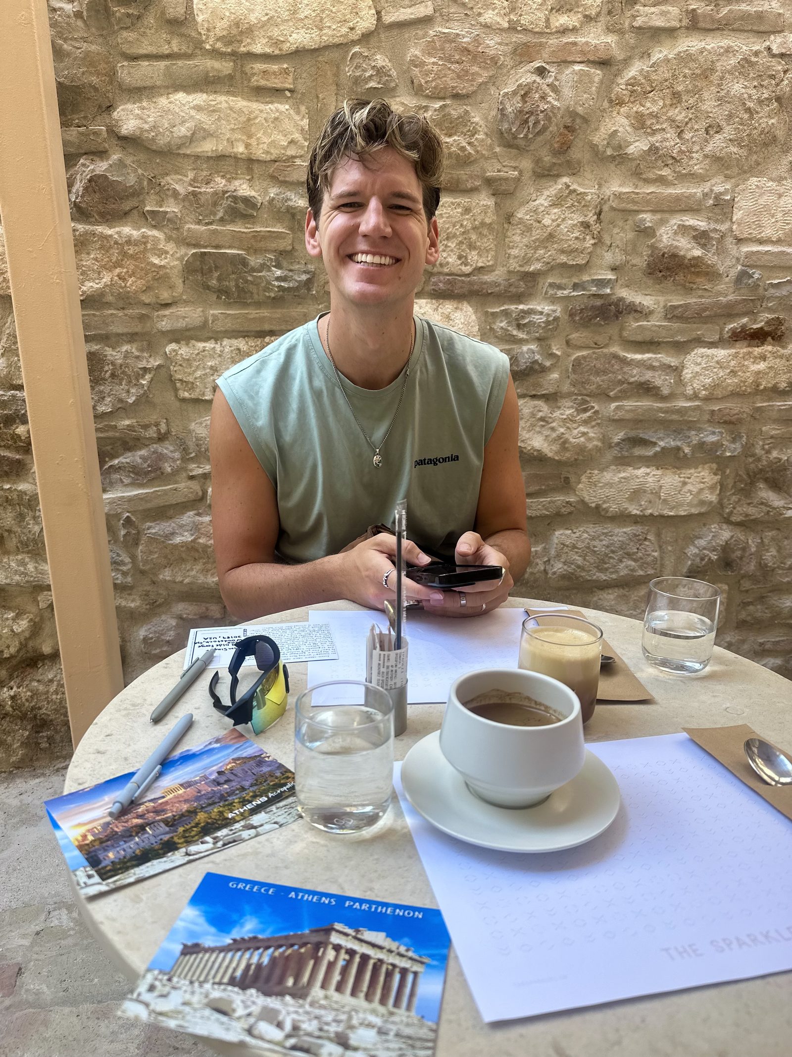 Ryker smiling at a table with coffee